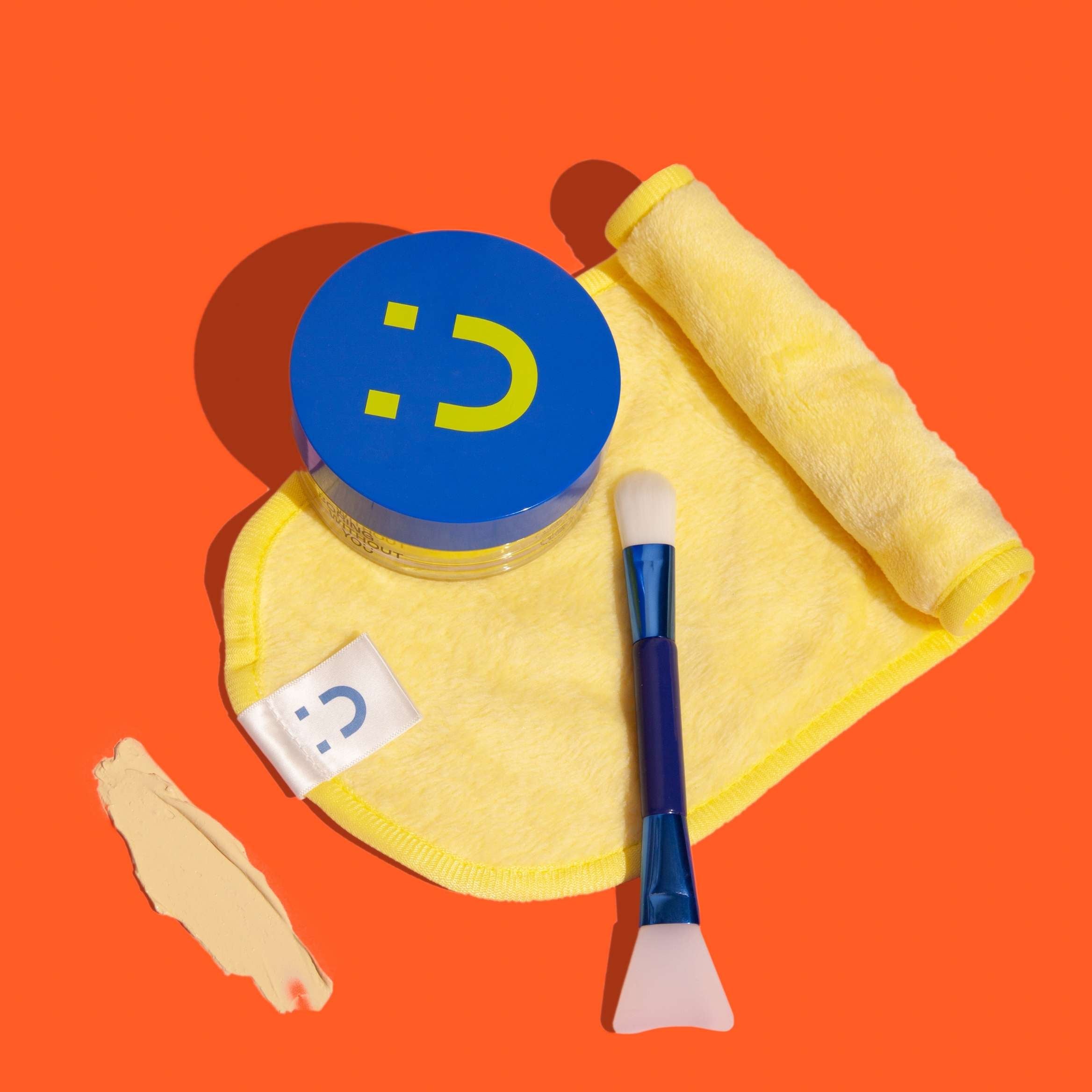 Skincare from Australia. Beauty without the bullshit, big softie face cloth, duo brush on orange background. Boring Without You skincare.